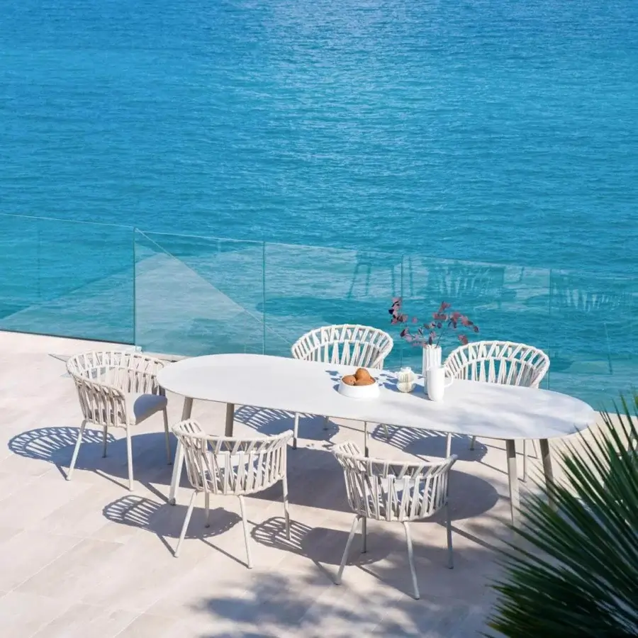 Elegant Varaschin Emma table crafted in Italy with a light gray bush-hammered ceramic top and powder-coated aluminum frame