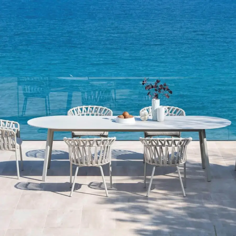 Distinguished Varaschin Emma table with a light gray bush-hammered ceramic top and powder-coated aluminum frame