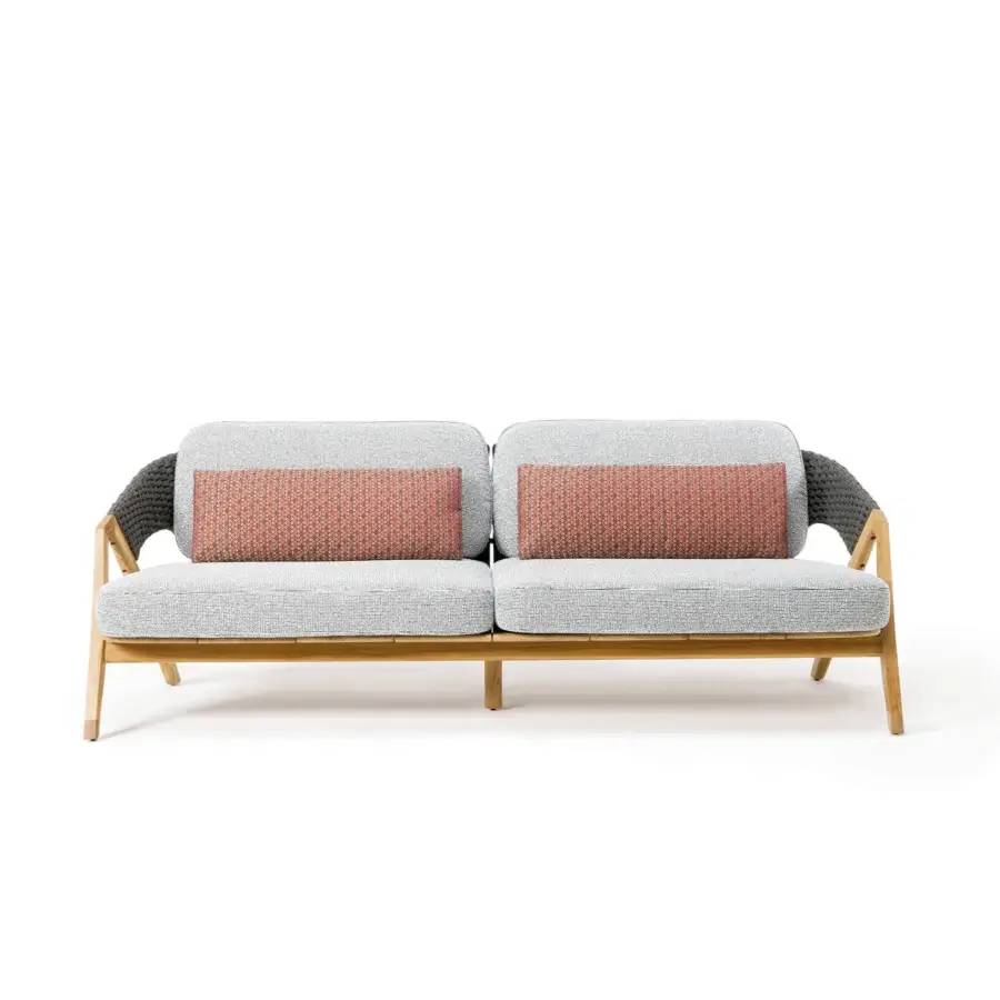 Distinguished Ethimo Knit sofa with sinuous teak frame, light gray textile upholstery and reddish-orange patterned cushions crafted in Italy