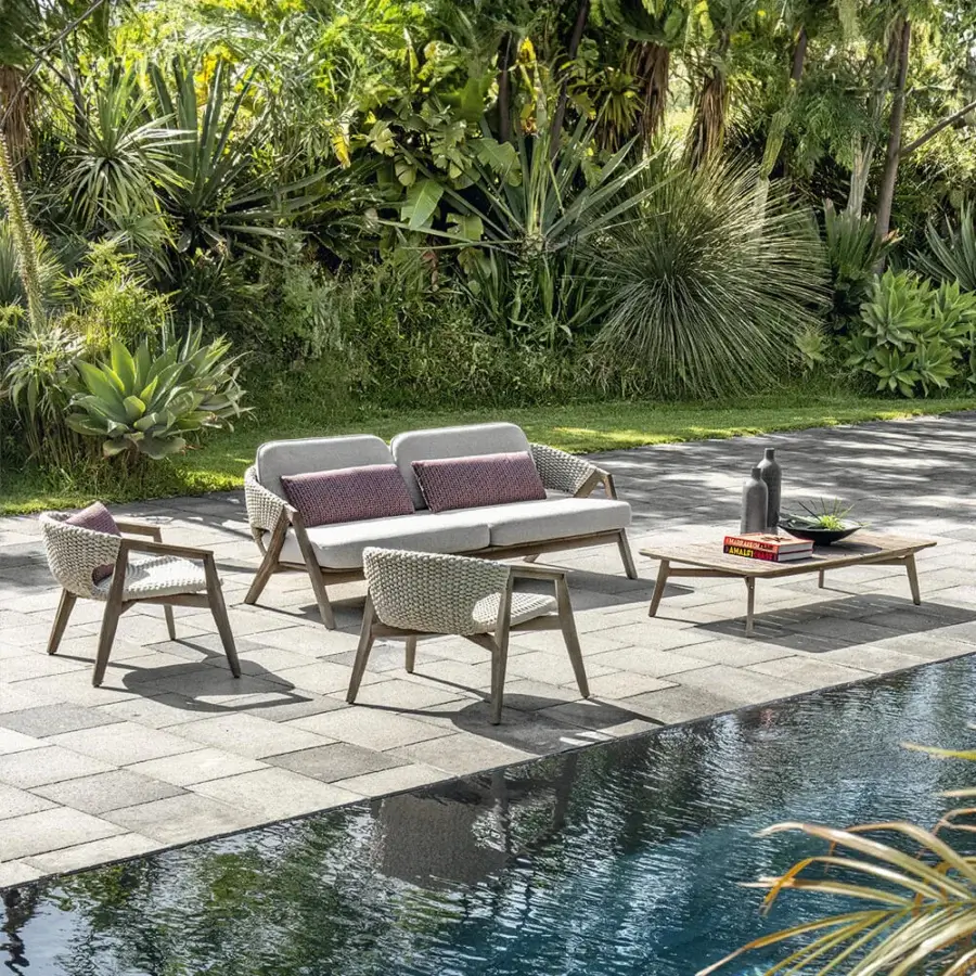 Distinguished Ethimo Knit sofa with sinuous teak frame and captivating coral-red cushions crafted in a rope weave backrest