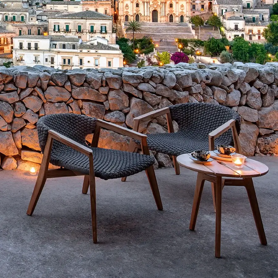 Sophisticated Ethimo Knit lounge chair with dark gray woven rope and satin-sheen FSC-certified teak frame