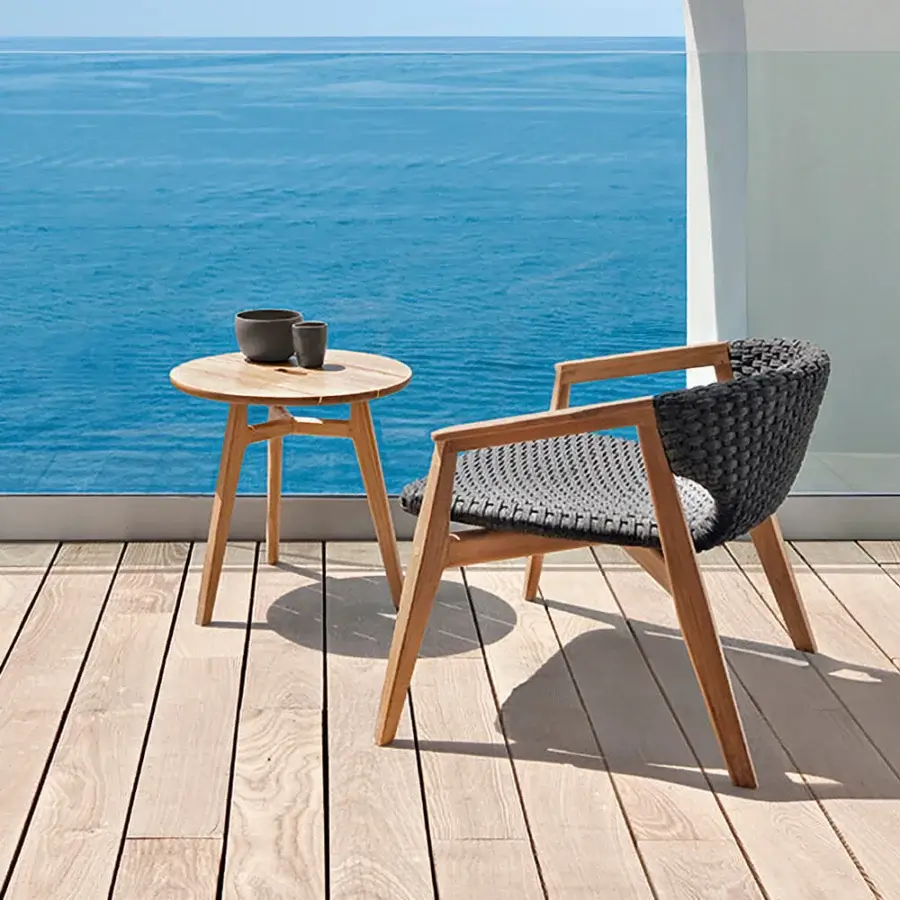 Exceptional Ethimo Knit lounge chair crafted with warm light brown teak and dark gray high-density woven rope for relaxing comfort