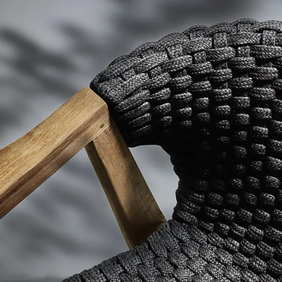 Sophisticated Ethimo Knit lounge chair with a sinuous FSC-certified teak frame and dark gray woven rope seat and back