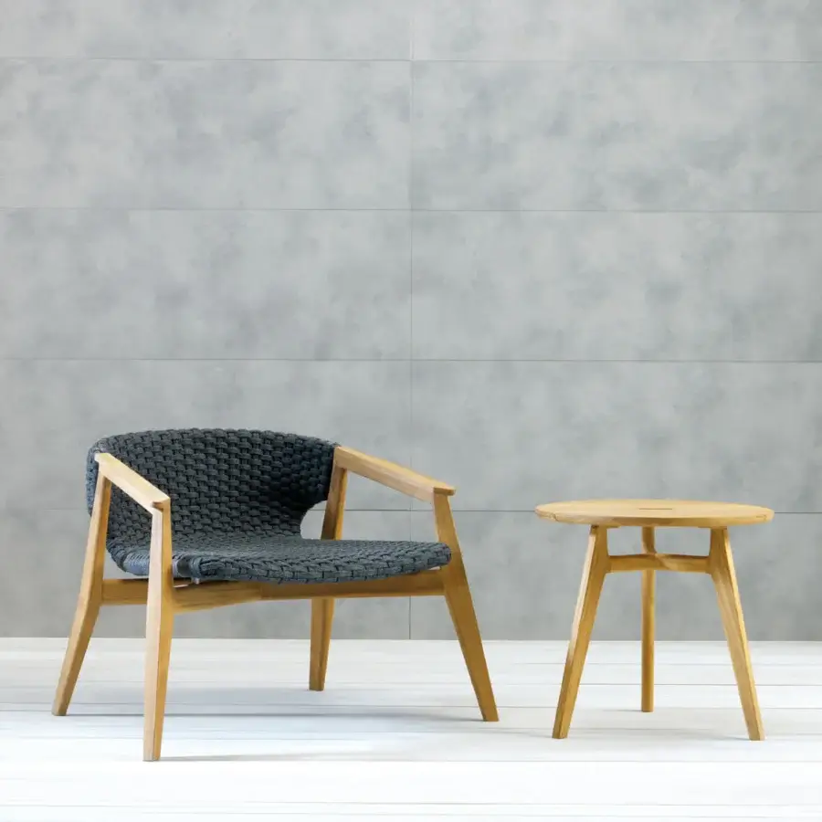 Distinguished Ethimo Knit lounge chair with a sinuous FSC-certified teak frame and dark gray-black woven seat back