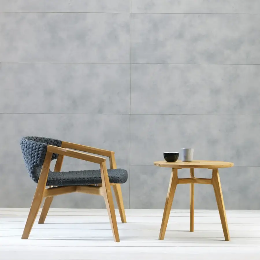 Sophisticated Ethimo Knit lounge chair with dark gray woven rope and a satin sheen FSC-certified teak frame
