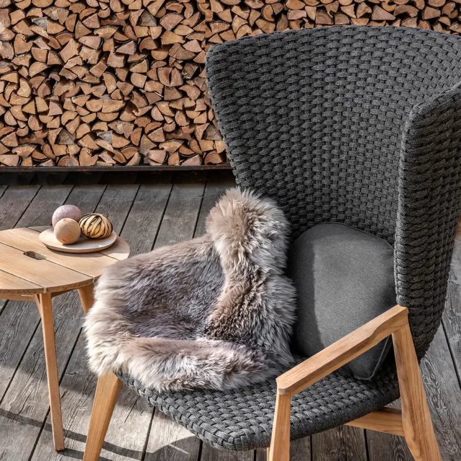 Sophisticated Ethimo Knit lounge chair with a hand-finished teak frame and dark charcoal gray woven rope backrest