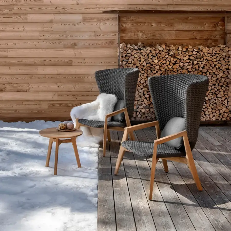 Lavish Ethimo Knit lounge chair with a hand-finished teak frame and dark gray woven knit backrest