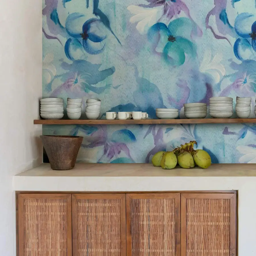 Distinguished Wall&Decò Narciso wallpaper with large-scale floral patterns in watercolor-inspired shades of blue, purple and teal