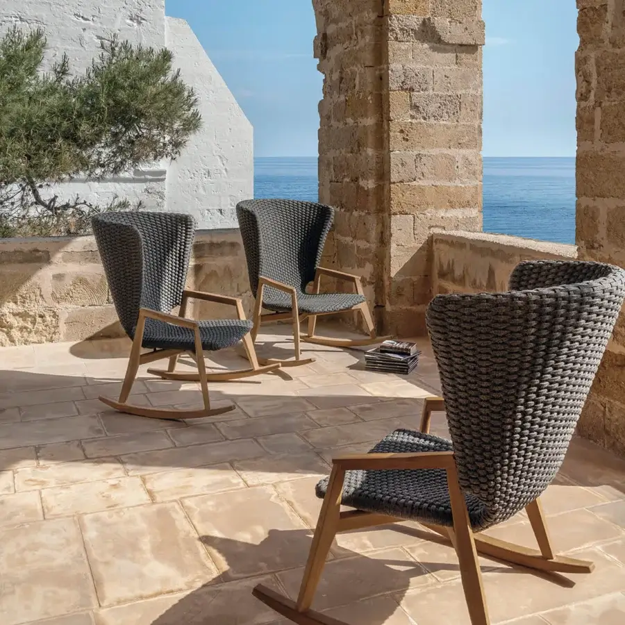 Superior Ethimo Knit rocking lounge chair with FSC-certified teak frame and dark gray woven flat rope seat with satin wood finish