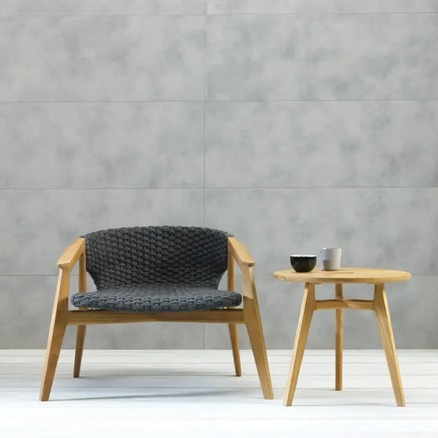 Exceptional Ethimo Knit side table crafted in warm teak wood with a smooth satin finish and distinctive X-shaped stretcher