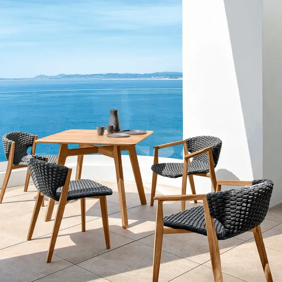 Exceptional Ethimo Knit armchair with a wrap-around dark gray woven rope backrest and hand-finished teak frame