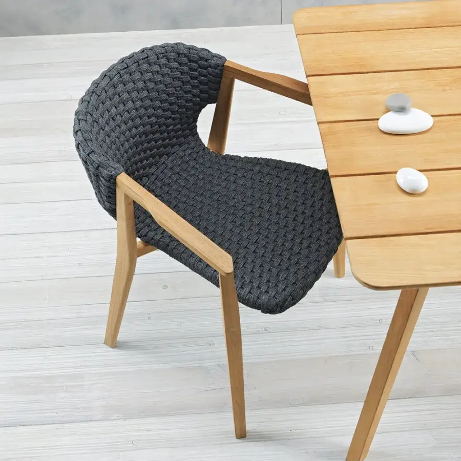 Captivating Ethimo Knit armchair with dark charcoal gray woven texture and sinuous hand-finished FSC-certified teak frame