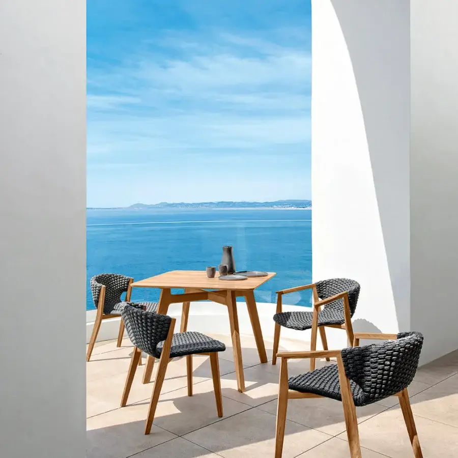 Elegant Ethimo Knit table crafted in medium-toned brown teak with a satin sheen and gently tapered legs