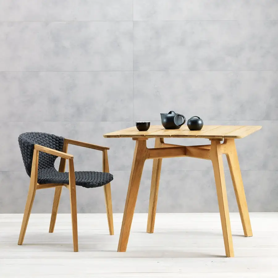 Distinguished Ethimo Knit table crafted in warm medium-toned brown FSC-certified teak with a satin sheen