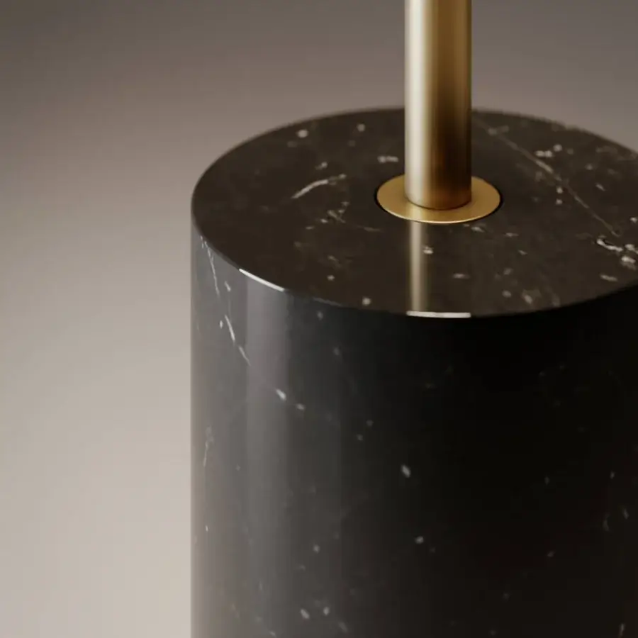 Distinguished VENICEM Doma floor lamp with dark stone base and slender gold-finished metal stem emitting warm downlight