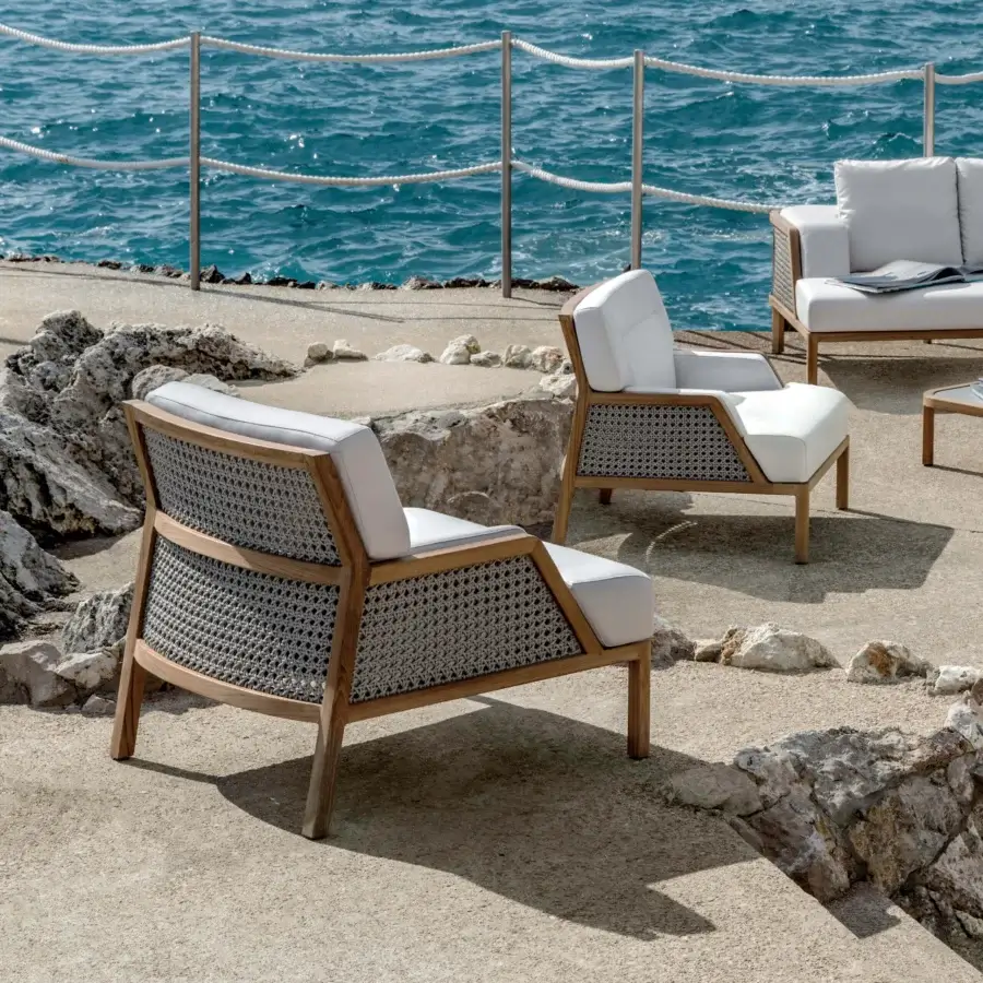 Lavish Ethimo Grand Life lounge chair with warm wood and light beige woven back and sides crafted in Italy