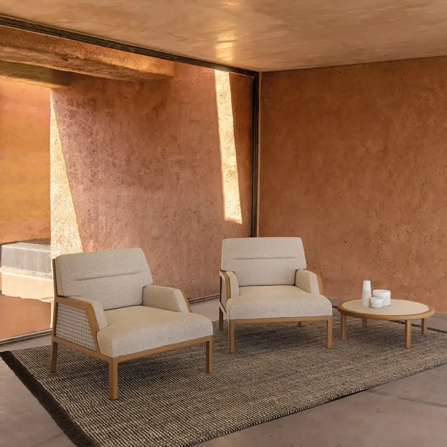 Elegant Ethimo Grand Life lounge chair with warm wood and refined woven textile upholstery in a neutral beige tone
