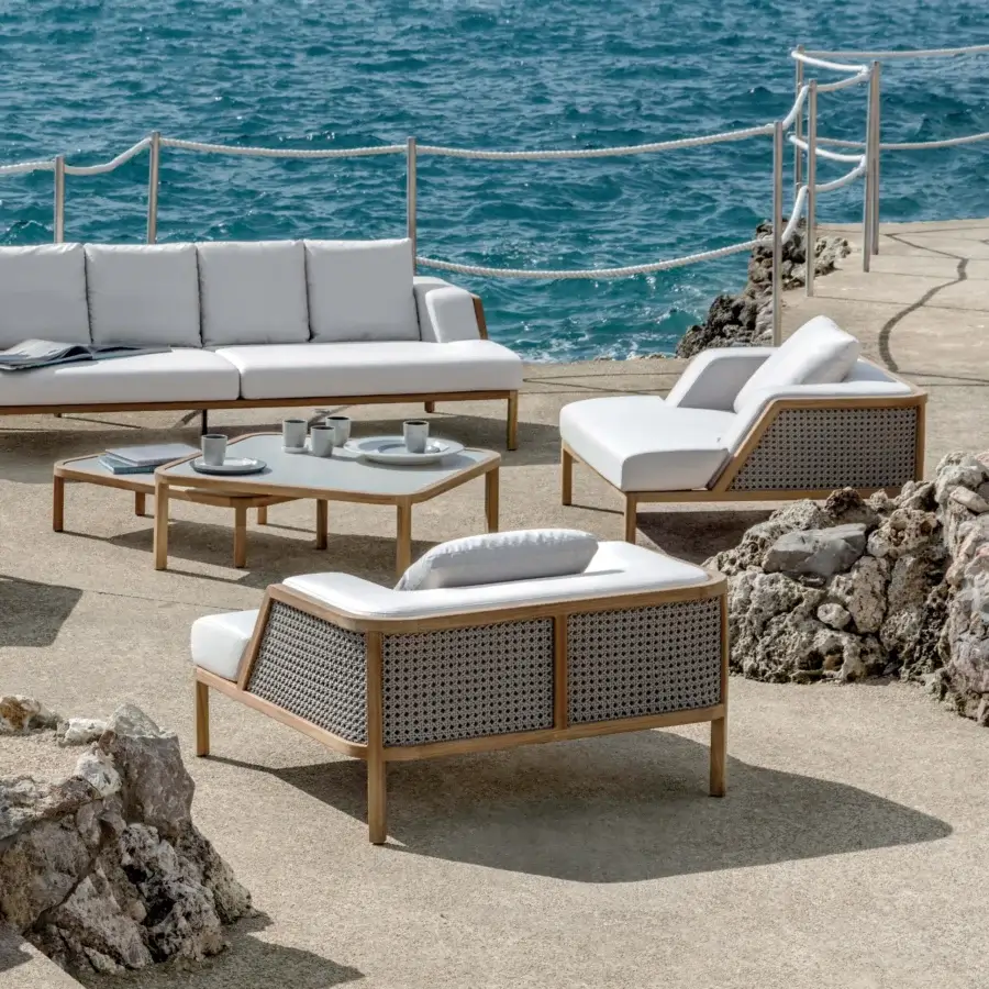 Superior Ethimo Grand Life lounge chair with warm brown wooden frame and Vienna straw-inspired weave with white cushions