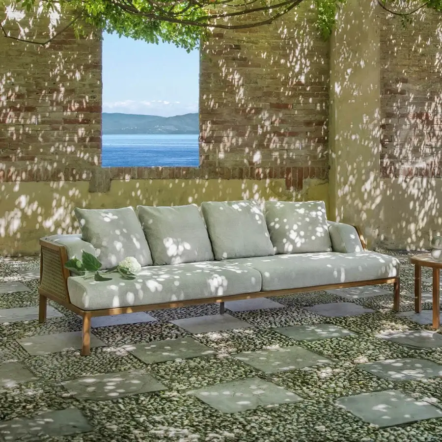 Distinguished Ethimo Grand Life sofa crafted in Italy with satin-finish wood and woven detail, upholstered in muted sage green textile