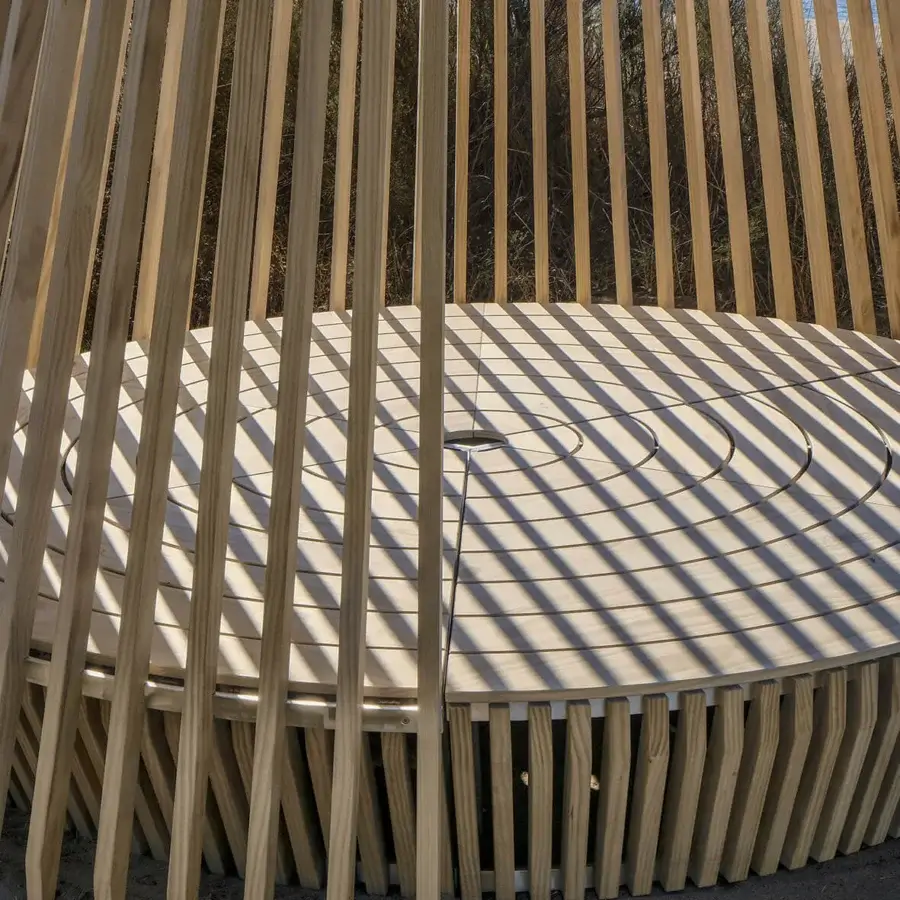 Distinctive Ethimo Hut daybed crafted in light-toned wood with radiating vertical slats and satin finish