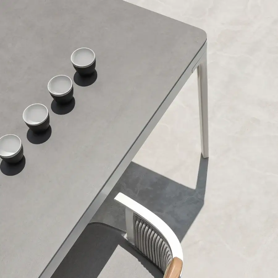 Harmonious Ethimo Play table with matte gray synthetic tabletop and light-colored powder-coated metal legs