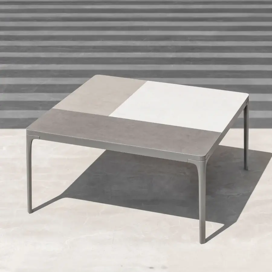 Distinguished Ethimo Play table with a two-tone grey and off-white composite tabletop and sleek metal frame in a matte finish