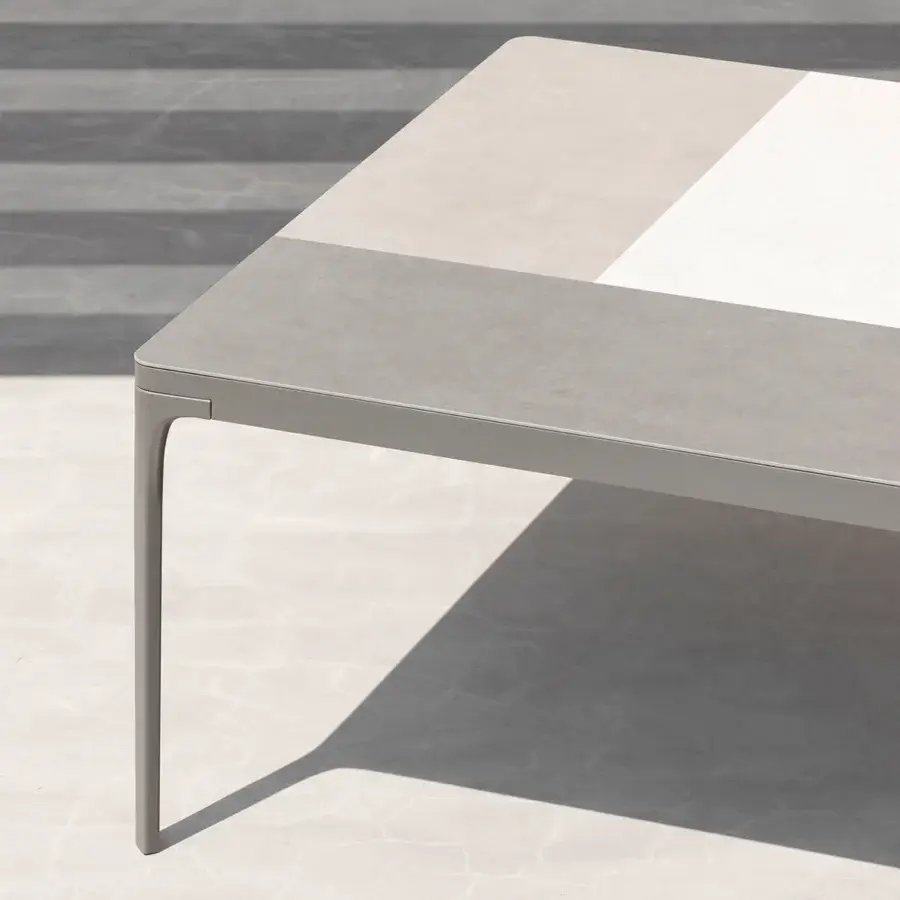 Superior Ethimo Play table with a patchwork light and dark gray composite tabletop and matte gray metal leg
