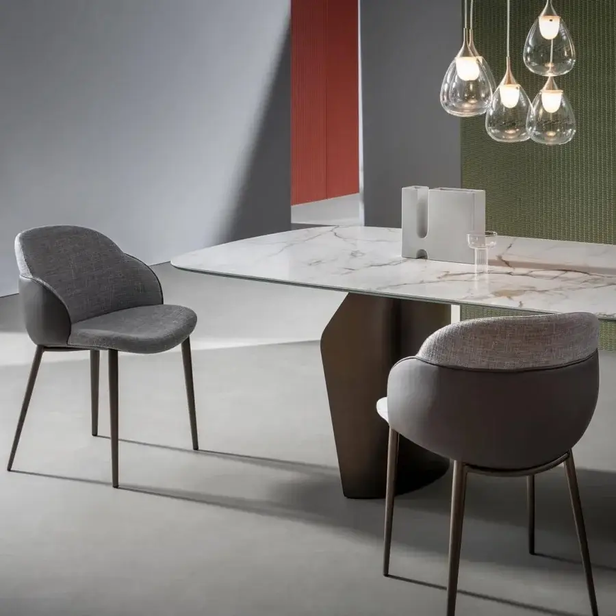 Elegant Bonaldo Flame table with a white ceramic top displaying light brown veining and a bronze finished metal base