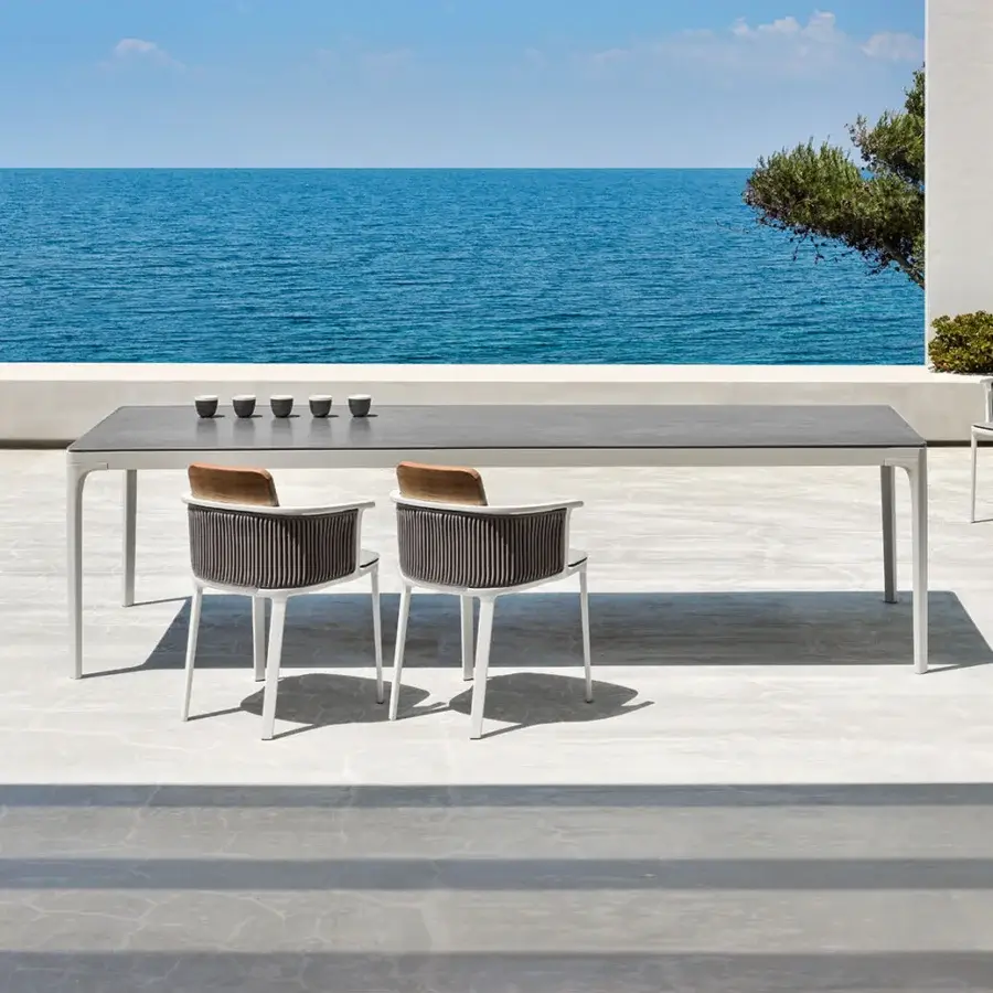 Distinguished Ethimo Play table with dark gray stone composite tabletop and light gray metal base in matte finish