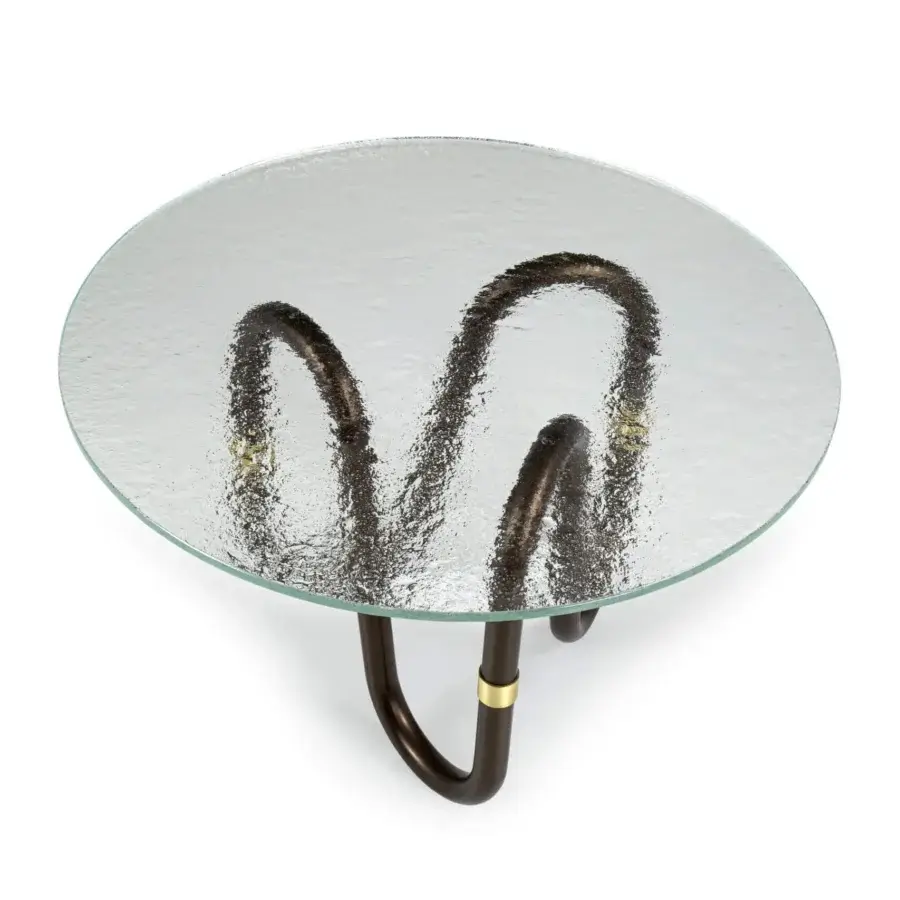 Elegant Borzalino Flow coffee table with transparent glass top and sinuous dark-toned metal base crafted with a subtle brass joint ring