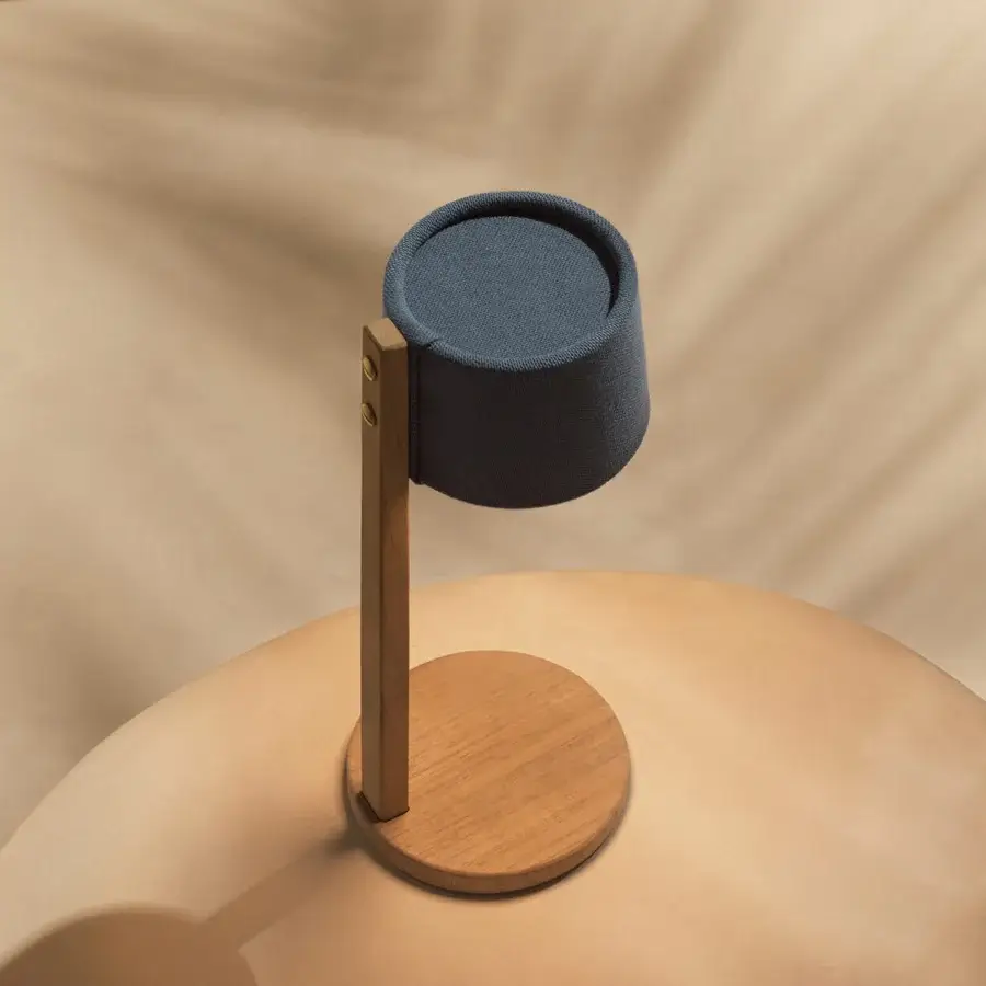 Distinctive Ethimo Gaia table lamp with a textured dark blue-gray fabric shade and satin-finish wood base crafted in Italy