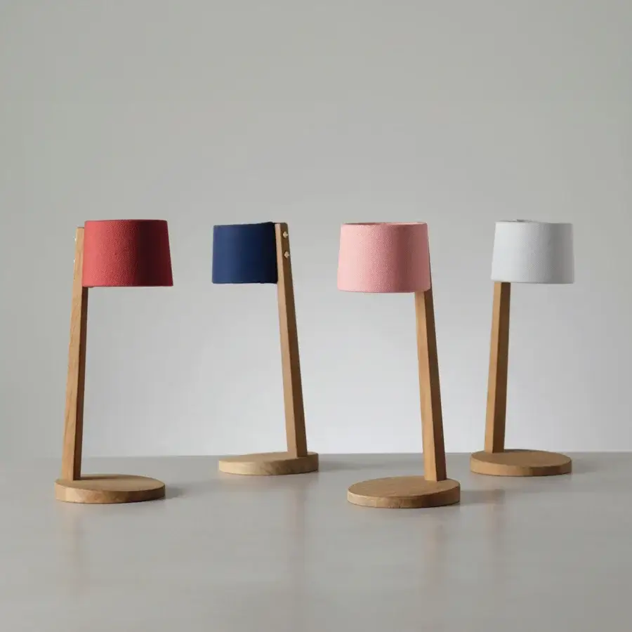 Elegant Ethimo Gaia table lamp in pale pink with satin-finish wood crafted for soft cordless illumination