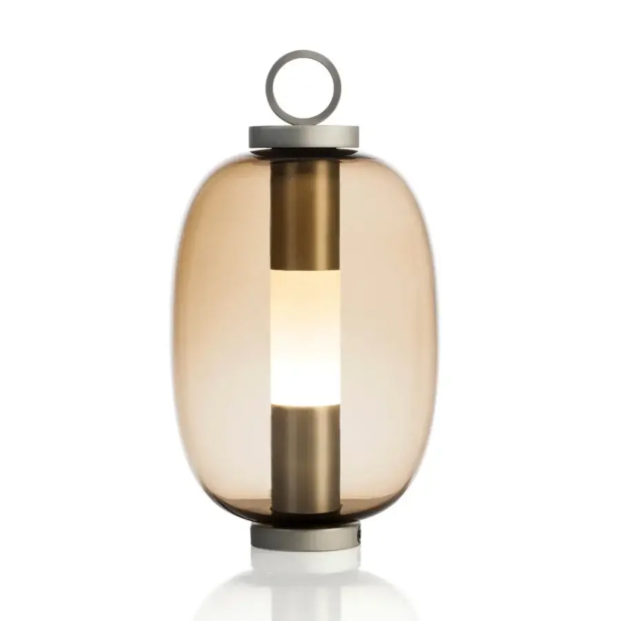 Distinctive Ethimo Lucerna table lamp with elongated form in amber glass and satin brass-toned metal accents