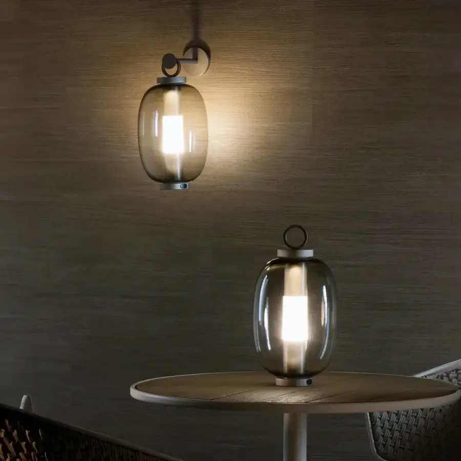 Elegant Ethimo Lucerna wall lamp reimagines a classic form with translucent glass in smoky grey and matte black metal bracket