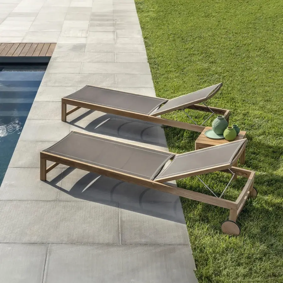 Elegant Ethimo Sand lounger crafted in Italy with a satin wooden frame and sleek gray textile surface