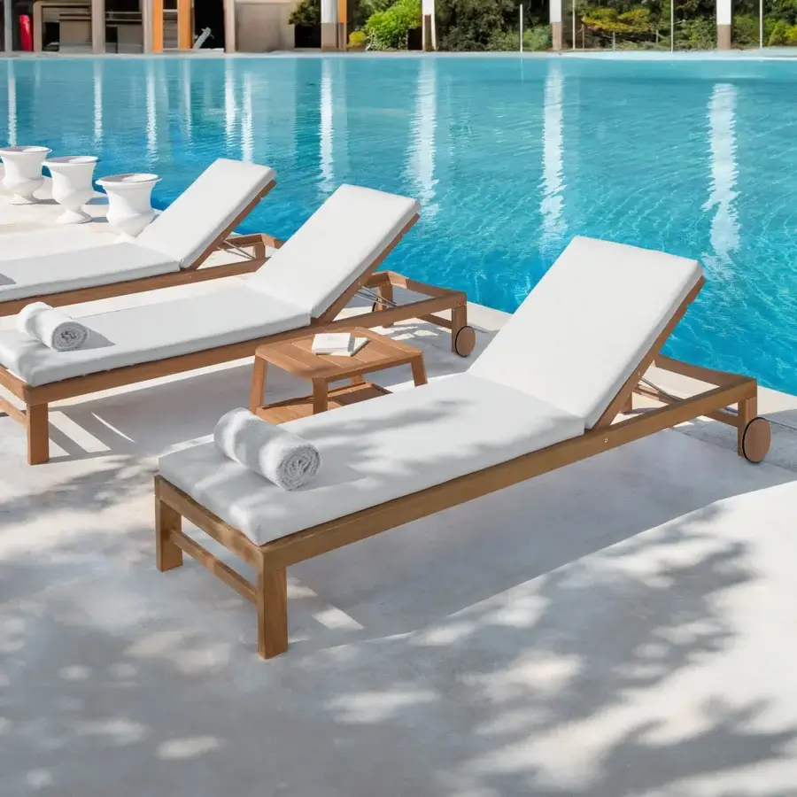 Elegant Ethimo Sand lounger with a satin-finish medium brown wood frame and comfortable white textile cushion