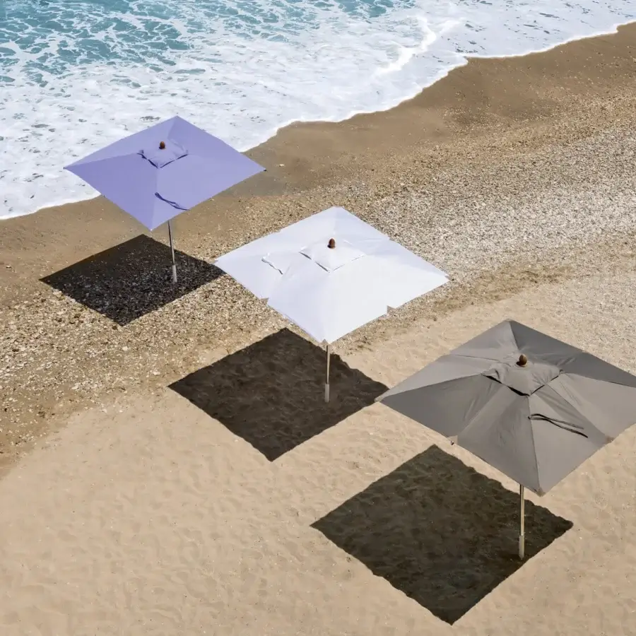 Elegant Ethimo Free Umbrella parasol in pale lavender textile with a matte metal pole