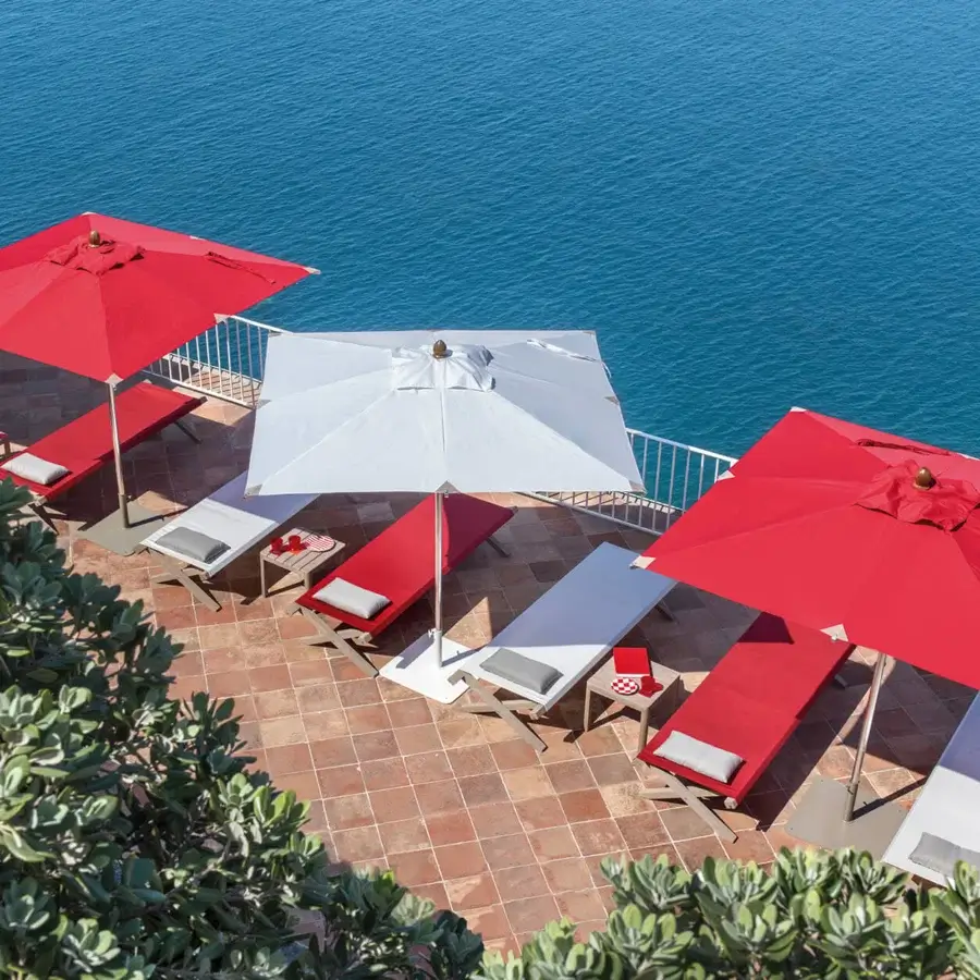 Distinguished Ethimo Free Umbrella parasol in vibrant red textile with a sleek metal frame embodying a contemporary design