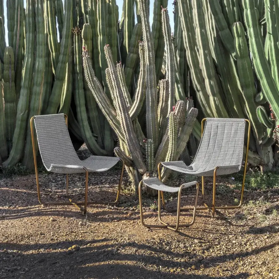 Distinguished Ethimo Sling lounge chair with a warm-toned brass metal frame and light grey woven textile finish
