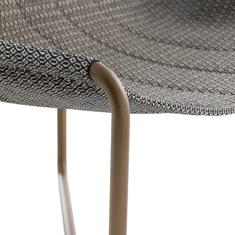 Elegant Ethimo Sling lounge chair with woven textile in muted gray and dark blue tones with a bronze-like matte metal frame