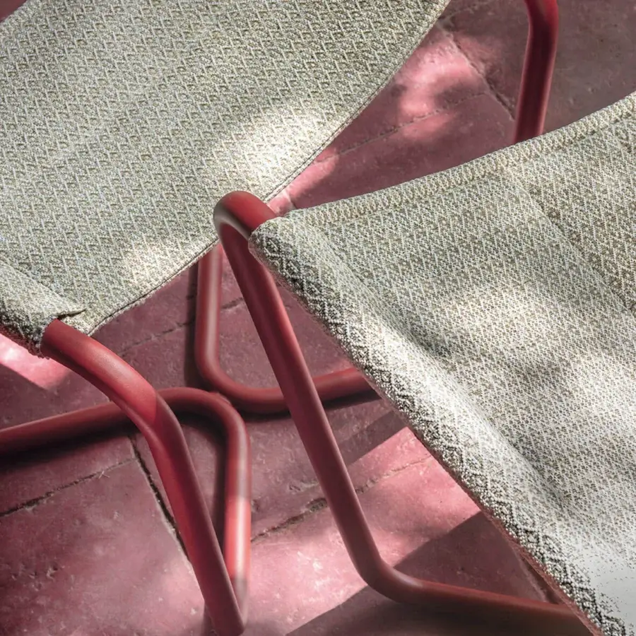 Distinguished Ethimo Sling lounge chair with reddish-brown metal frame and neutral textured textile offering comfortable sprawling seating