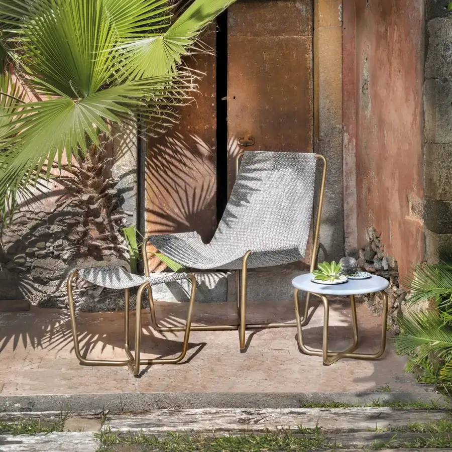 Elegant Ethimo Sling lounge chair with light gray woven mesh seating and matte golden-toned metal frame crafted in Italy