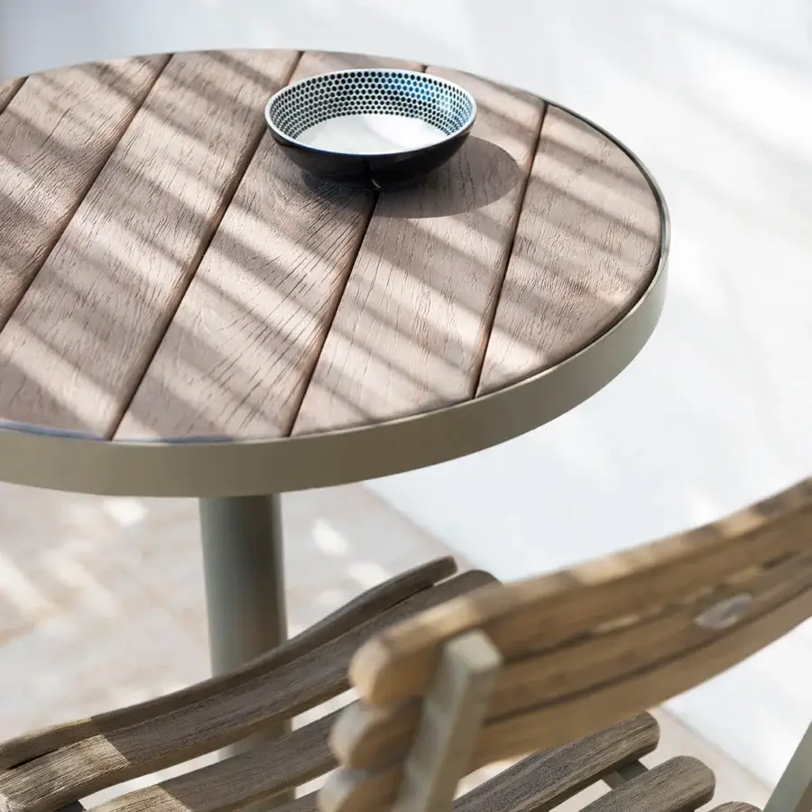Superior Ethimo Laren Bistrot table with medium-brown wooden slats and matte light-colored metal base