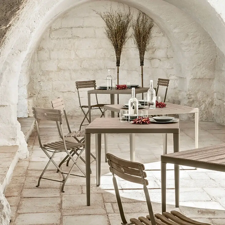 Sophisticated Ethimo Laren table crafted in teak with a matte finish embodies minimalist aesthetics and warm gray-brown tones