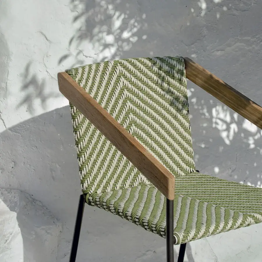 Distinctive Ethimo Allaperto Bistrò armchair crafted with wood frame, metal base, and chevron-woven muted green seat and back