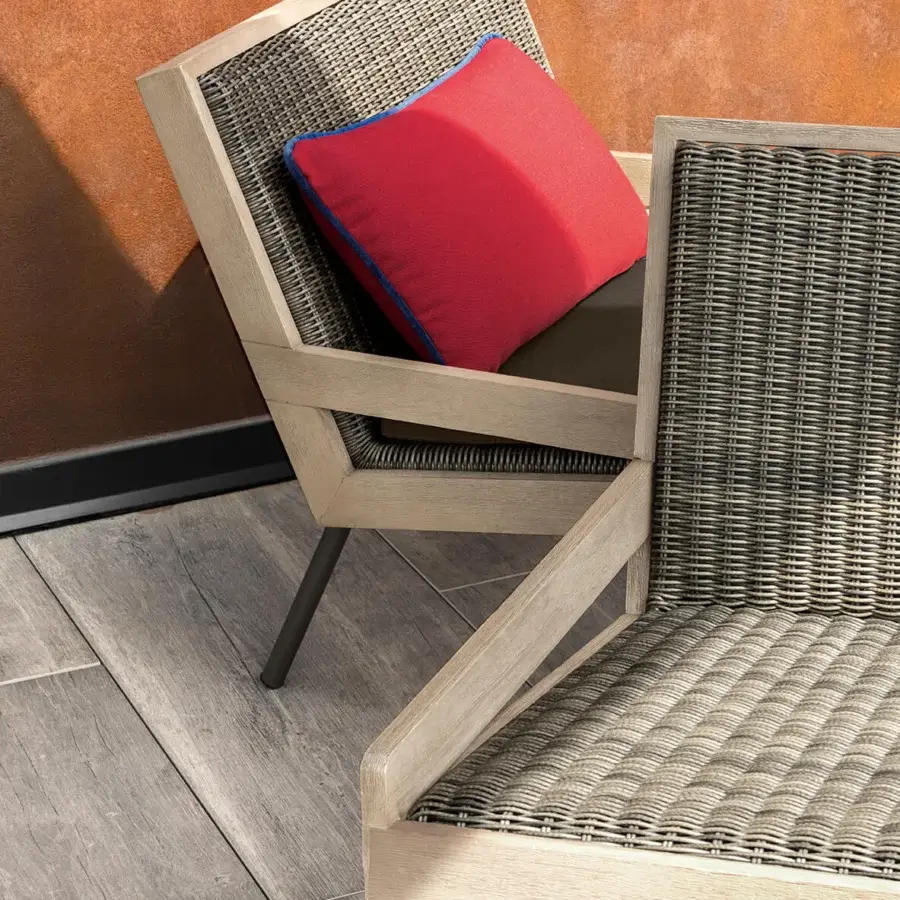 Distinguished Ethimo Allaperto lounge chair crafted in gray synthetic wicker with a light matte wood frame and vibrant red cushion