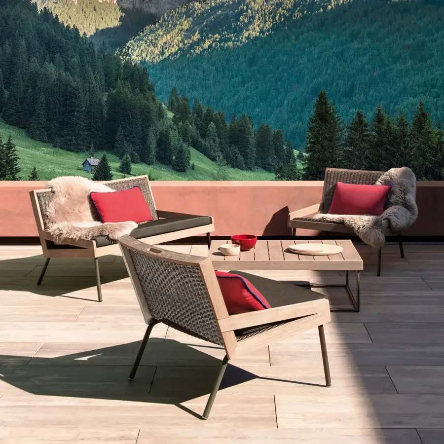 Sophisticated Ethimo Allaperto lounge chair with charcoal woven seat and satin-finish brown wood frame complemented by vibrant red cushions