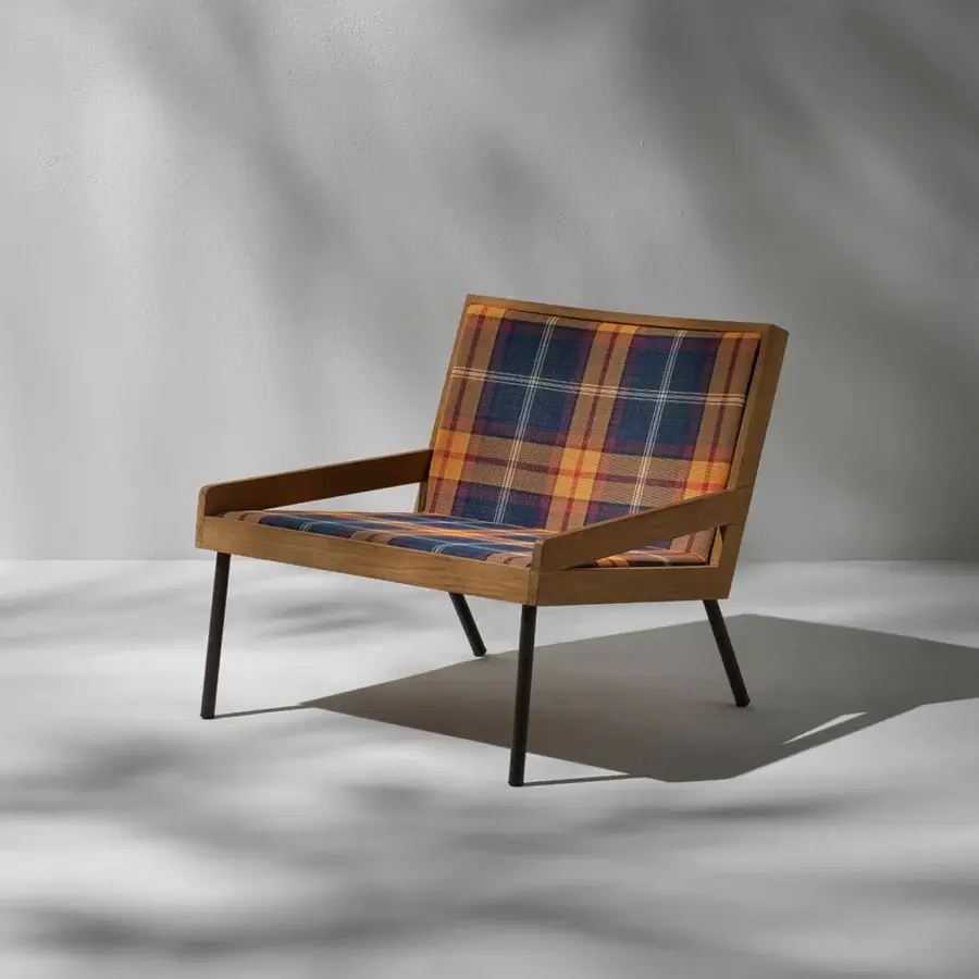 Elegant Ethimo Allaperto lounge chair with blue, gold, and orange textile upholstery and satin-finish wood frame