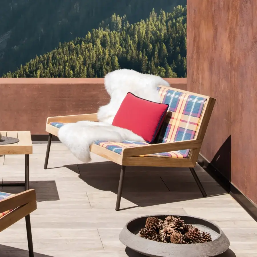Sophisticated Ethimo Allaperto two-seater sofa with vibrant plaid textile upholstery and satin-finish wood frame