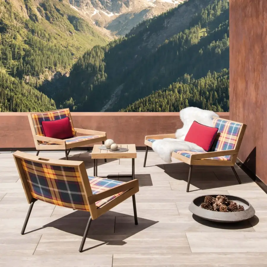 Exceptional Ethimo Allaperto two-seater sofa built with medium-brown wood and satin finish, displaying vibrant plaid cushions